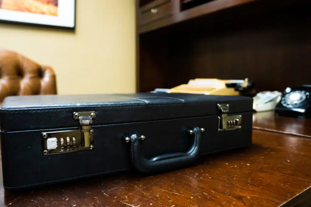 An image of the Mob Boss escape room at Escape This Frederick. Looking at an old briefcase on a desk.